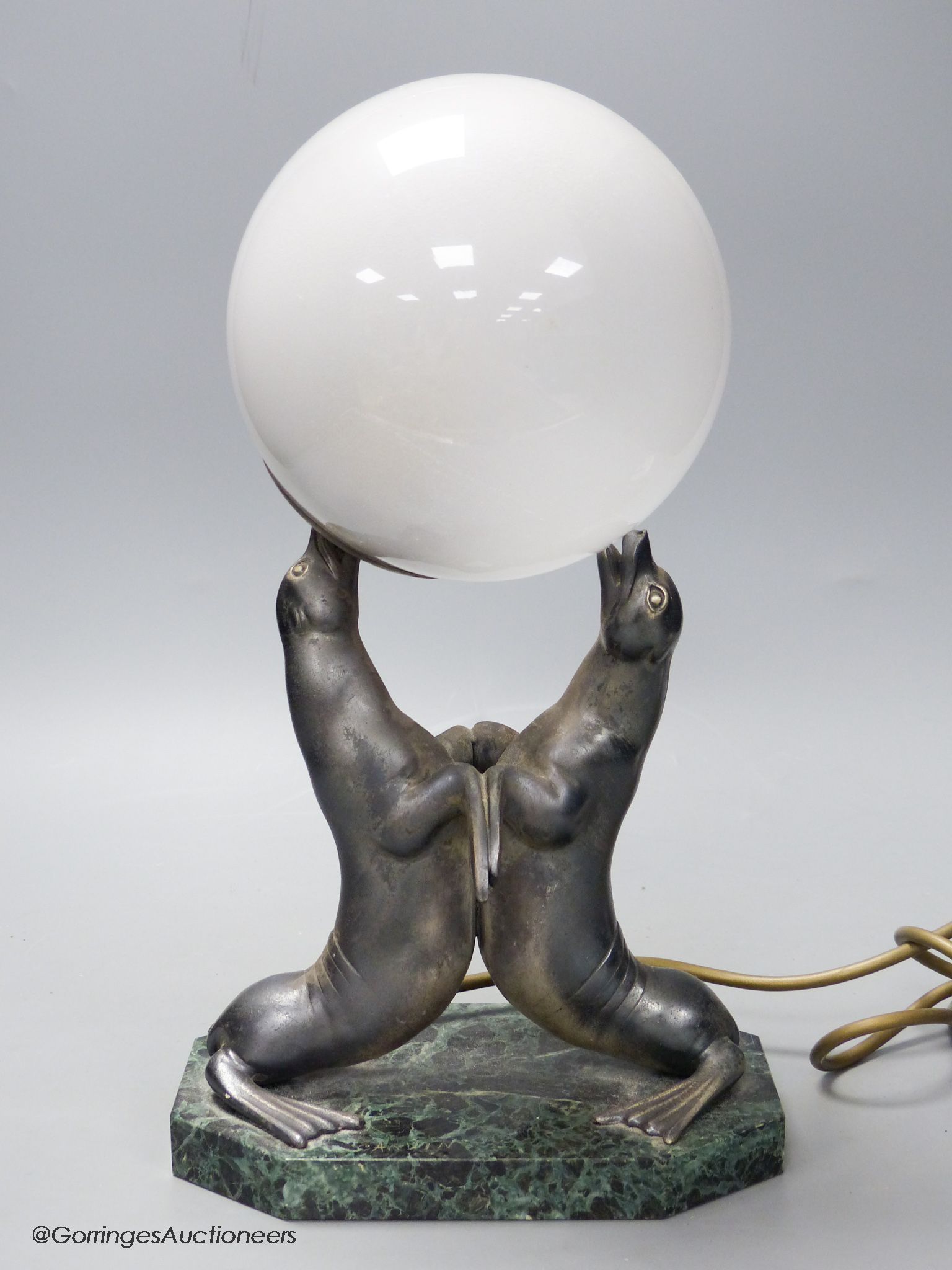 An Art Deco spelter and marble sea-lion desk lamp, height 34cm